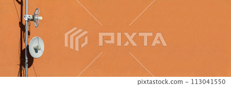 Two telecommunications antennas used for cellular network and wireless Internet, fixed on the building wall. Receiving and digitizing multiple pieces of information at once. Panoramic frame. 113041550