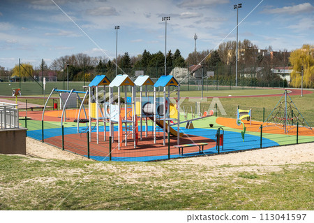 A playground for children to play. Colorful play sets and a safe surface. Coniferous tree branch with cones. Pine. A playground for children to play. Colorful play sets and a safe surface. Coniferous tree branch with cones. Pine. 113041597