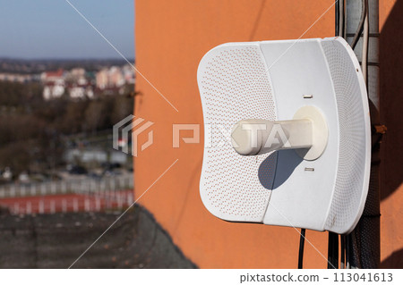 Telecommunications antenna mounted on the building's sewing, used for data transmission in cellular networks and providing wireless internet. Telecommunications antenna mounted on the building's sewing, used for data transmission in cellular networks and providing wireless internet. 113041613