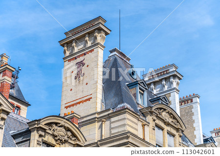 Close view of Sorbonne University historical building rooftop showing intricate stonework and tiled patterns. Paris, France 113042601