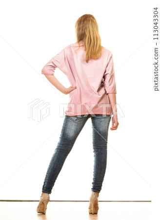 woman in denim pants high heels shoes back view woman in denim pants high heels shoes back view 113043304