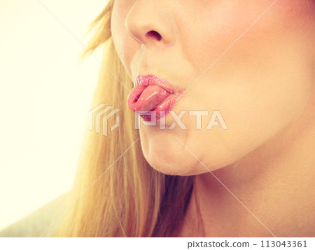 Funny blonde woman sitcking tongue out 113043361