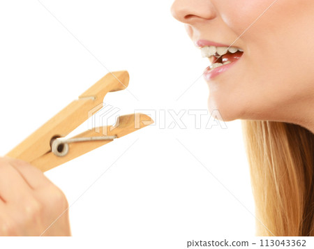 Blonde woman having tongue in clothespin Blonde woman having tongue in clothespin 113043362