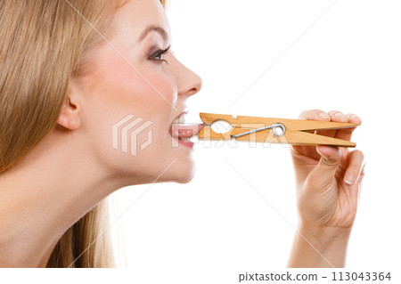 Blonde woman having tongue in clothespin Blonde woman having tongue in clothespin 113043364