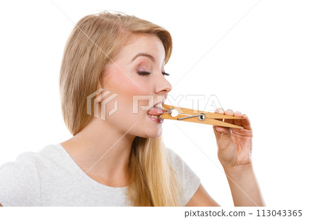 Blonde woman having tongue in clothespin Blonde woman having tongue in clothespin 113043365