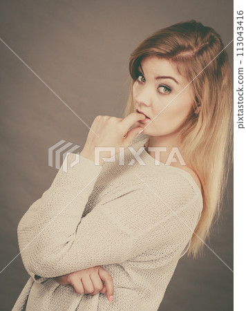 Blonde woman contemplating thinking about something Blonde woman contemplating thinking about something 113043416