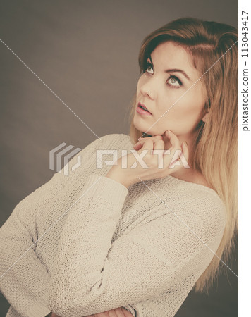 Confused young blonde woman looking annoyed Confused young blonde woman looking annoyed 113043417