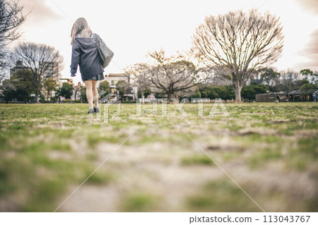 high school girl walking in the park 113043767