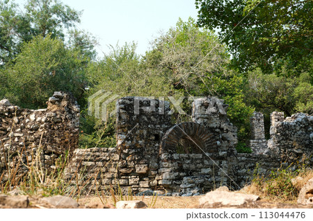 Ruins of Great Basilica in Butrint National Park, Buthrotum, Albania. Triconch Palace at Butrint Life and death of an ancient Roman house Historical medieval Venetian Tower surrounded. High quality 113044476