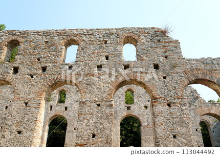 Ruins of Great Basilica in Butrint National Park, Buthrotum, Albania. Triconch Palace at Butrint Life and death of an ancient Roman house Historical medieval Venetian Tower surrounded. High quality 113044492