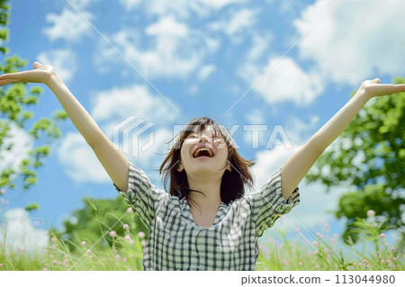 Woman Standing in Field With Arms Outstretched 113044980