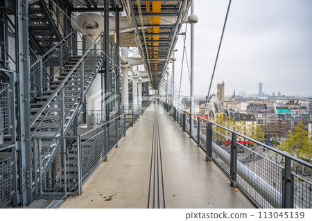 A deserted walkway with a cityscape view from the Centre Pompidou, showcasing modern architectural design. Paris, France A deserted walkway with a cityscape view from the Centre Pompidou, showcasing modern architectural design. Paris, France 113045139