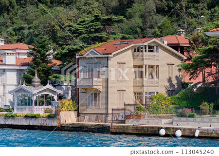 Green mountains of the Asian side of Bosphorus strait, with traditional houses and dense trees in a summer day Green mountains of the Asian side of Bosphorus strait, with traditional houses and dense trees in a summer day 113045240