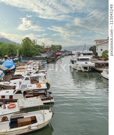 Goksu Stream, with docked boats, beside Anadolu Hisari castle on the Anatolian side of the Bosporus, Istanbul, Turkey 113045249