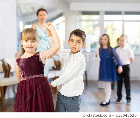 Tween girls ad boys dancing slow partner dance during festive event 113045626