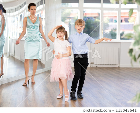 Boy and girl train to dance contemporary vigorous rumba during classes. Boy and girl train to dance contemporary vigorous rumba during classes. 113045641