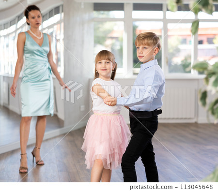 Boy and girl train to dance contemporary vigorous rumba during classes. Boy and girl train to dance contemporary vigorous rumba during classes. 113045648