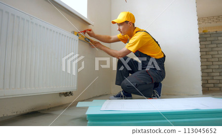 Builder is making repairs in the apartment. Preparation of walls for repair. 113045652