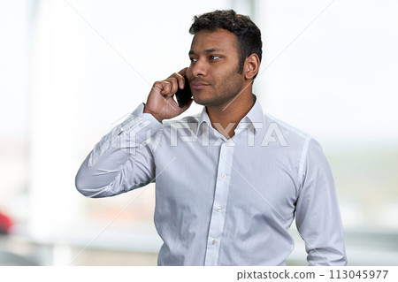 Confident businessman in white shirt talking on mobile phone. People, technology and lifestyle concept. Confident businessman in white shirt talking on mobile phone. People, technology and lifestyle concept. 113045977
