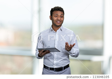 Handsome business trainer using tablet device. Blur interior background. People, business and modern technology concept. Handsome business trainer using tablet device. Blur interior background. People, business and modern technology concept. 113046105