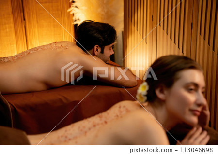 Couple customer having exfoliation treatment in luxury spa. Quiescent Couple customer having exfoliation treatment in luxury spa. Quiescent 113046698