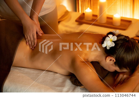 Caucasian woman customer enjoying relaxing anti-stress massage. Quiescent Caucasian woman customer enjoying relaxing anti-stress massage. Quiescent 113046744
