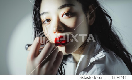 The picture of red lips young beautiful asian woman looking at camera . AIGX01. 113047461