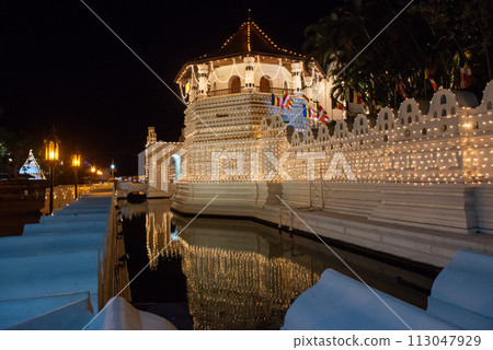 Night view of the octagonal pavilion named Paththirippuwa in Temple of the Sacred Tooth Relic a Buddhist temple in the city of Kandy, Sri Lanka. 113047929