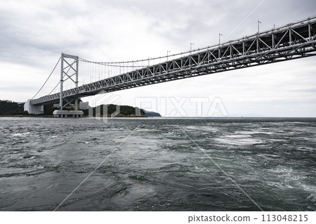 Naruto whirlpools on a cloudy day 113048215