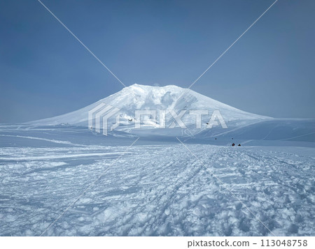 Asahidake on a clear day with a beautiful snowy landscape, a perfect day for winter mountain climbing with blue skies Asahidake on a clear day with a beautiful snowy landscape, a perfect day for winter mountain climbing with blue skies 113048758