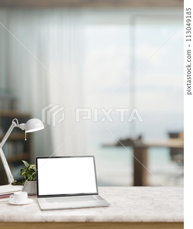 A modern home office with a laptop computer mockup and accessories on a white marble table. 113049185