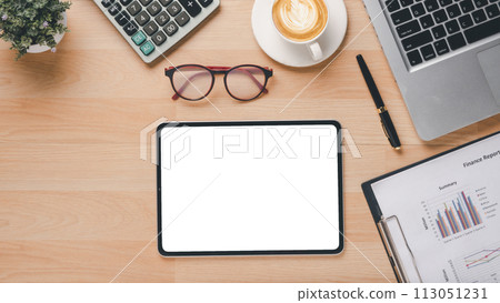 A tablet sits on a desk with a calculator, a cup of coffee, and a pen. The tablet is empty, and the scene suggests a work environment where someone might be working on a project or a report 113051231