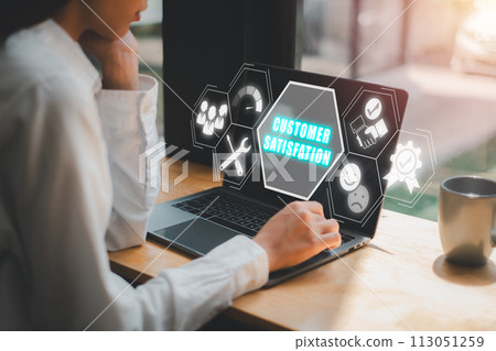Customer satisfation concept, Woman using laptop computer on cafe desk with customer satisfation icon on virtual screen. 113051259