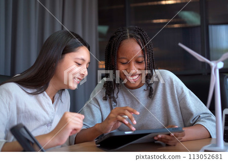 Group of international or multi ethnicity student having a discussion together about science project in class room. 113052681