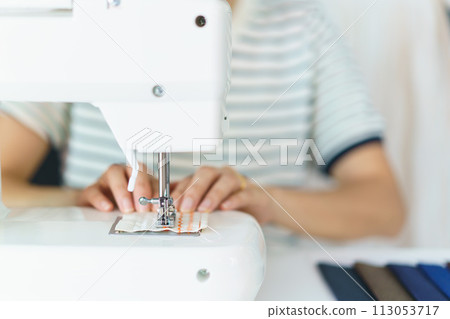 Happy beautiful Asian young woman working in the fashion design studio, professional female fashion designer portrait in design studio. 113053717