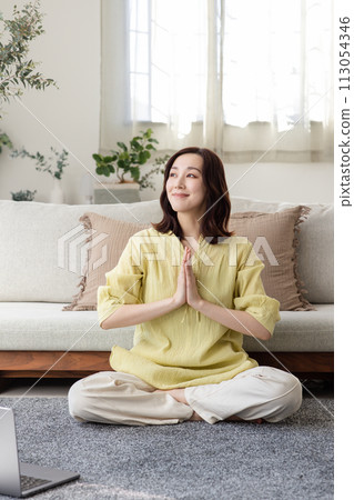 Beautiful woman doing yoga in her room 113054346