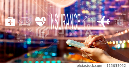 Insurance concept with person using a smartphone in city at night Insurance concept with person using a smartphone in city at night 113055032