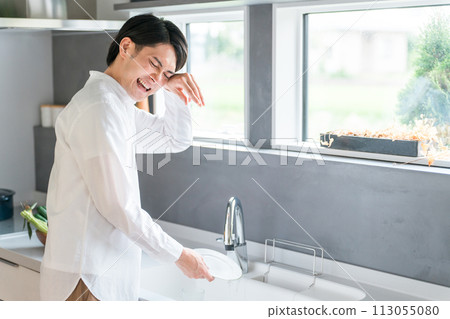 A man washing dishes in the kitchen (tired, hard, stressful, troublesome) A man washing dishes in the kitchen (tired, hard, stressful, troublesome) 113055080