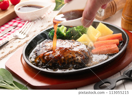 Hot hamburger steak cooked on a hot iron plate Hot hamburger steak cooked on a hot iron plate 113055215