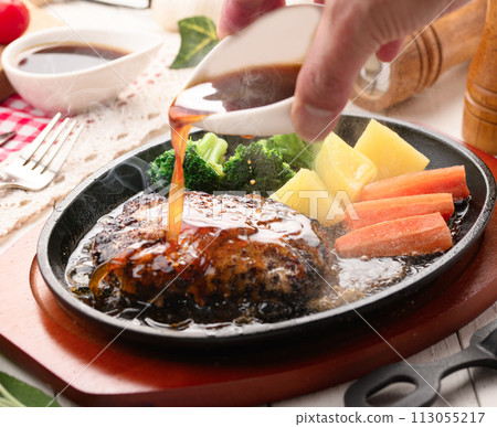 Hot hamburger steak cooked on a hot iron plate 113055217