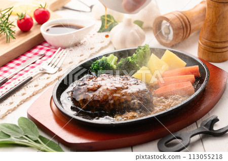 Hot hamburger steak cooked on a hot iron plate 113055218