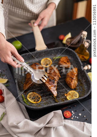 marinated pieces of Organic Tuna Steak frying on a hot grill pan marinated pieces of Organic Tuna Steak frying on a hot grill pan 113056991