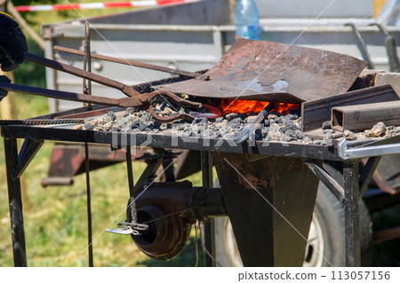 Hot coals in a forge brazier Hot coals in a forge brazier 113057156