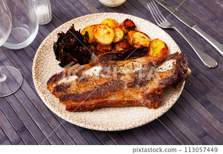 Portion of just cooked churrasco with potatoes and artichokes Portion of just cooked churrasco with potatoes and artichokes 113057449
