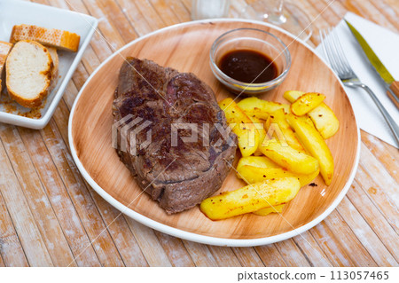 fried veal with French fries and spicy sauce 113057465