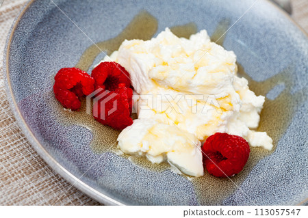 Catalan dessert - fresh cheese Mato with honey and strawberry 113057547