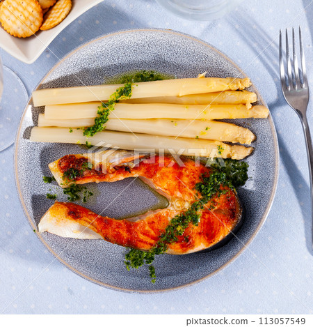 Roasted salmon steak and white asparagus on plate Roasted salmon steak and white asparagus on plate 113057549