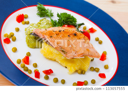 Roasted trout fillet with potato puree and guacamole 113057555