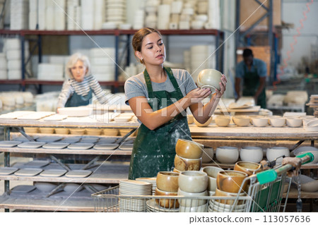 Young woman potter with new crafted ceramic bowls 113057636