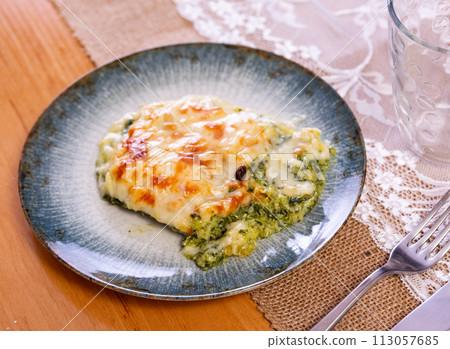 Lasagne with spinach served on platter 113057685